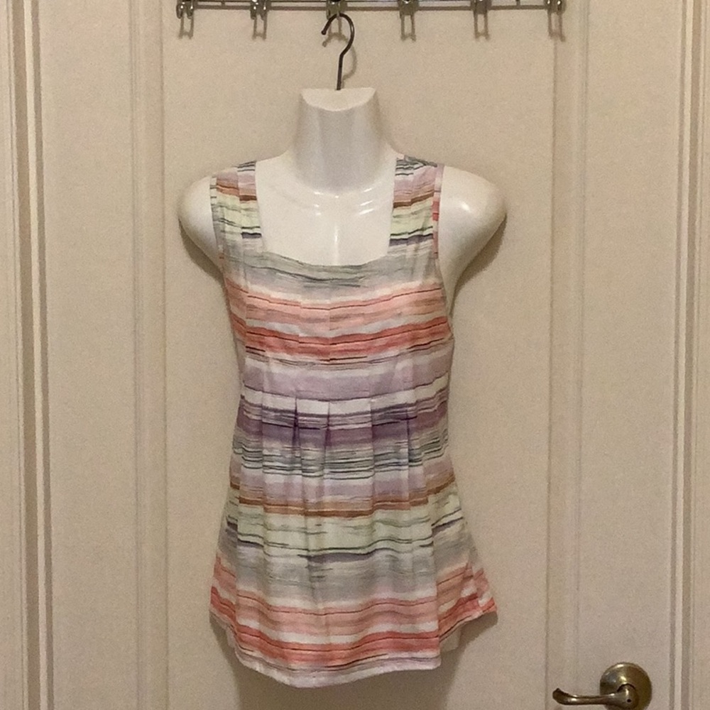 Summer top sleeveless colors of sherbet and it’s got a little brown purp…